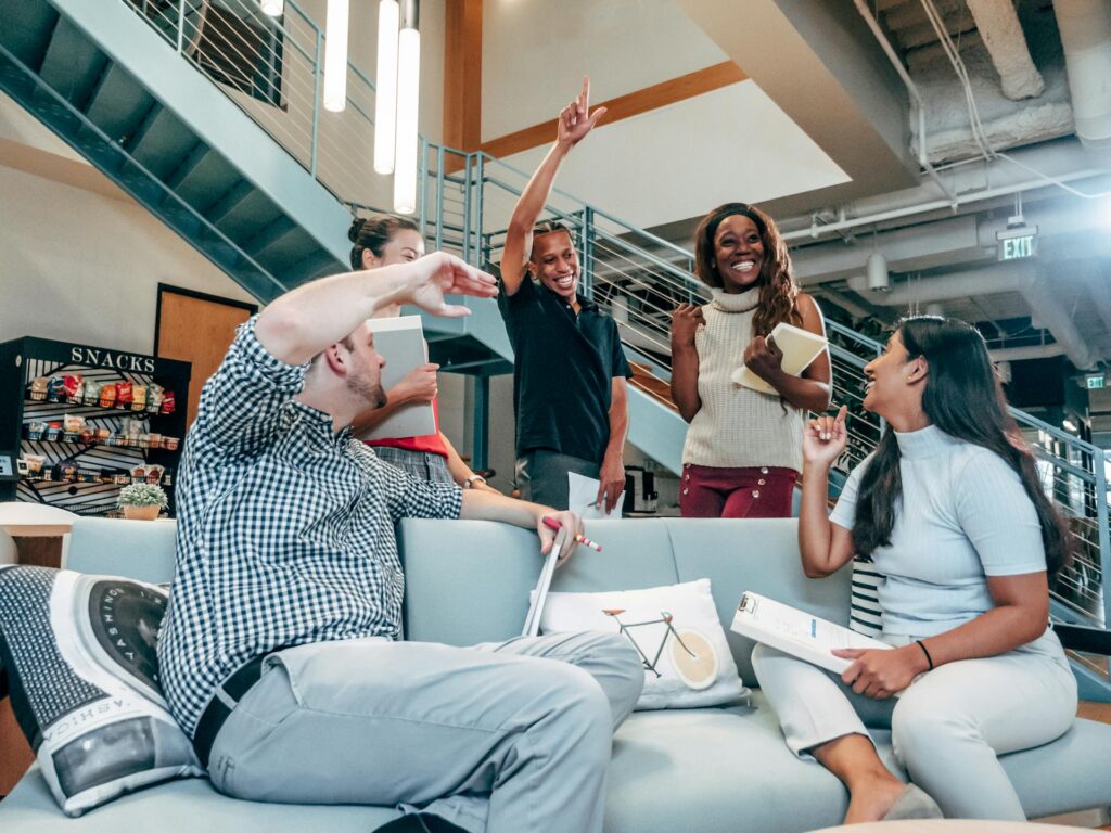 Team celebrating success in modern office lounge.