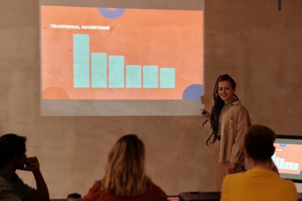 Woman presenting traditional advertising bar graph to audience.