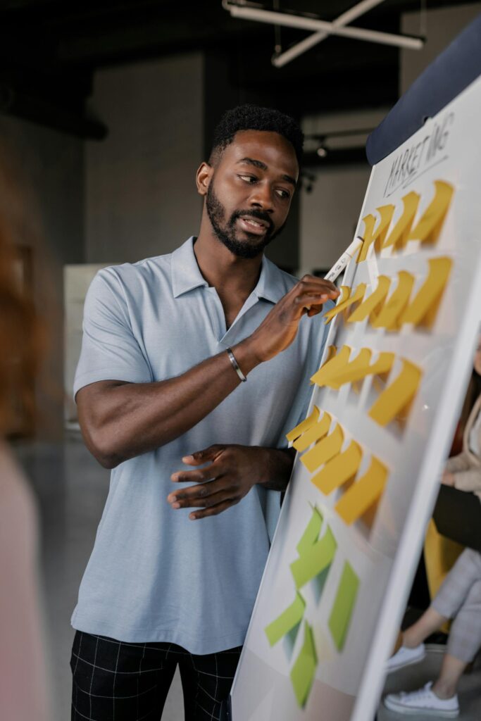 Man presenting marketing strategy with sticky notes.