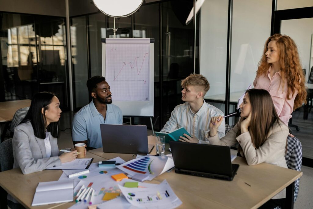 Team discussing graph in business meeting.