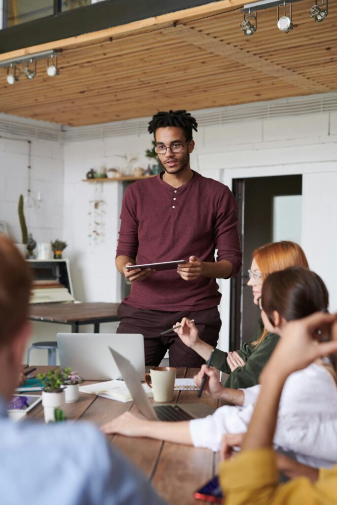 Man presenting at a modern office meeting.