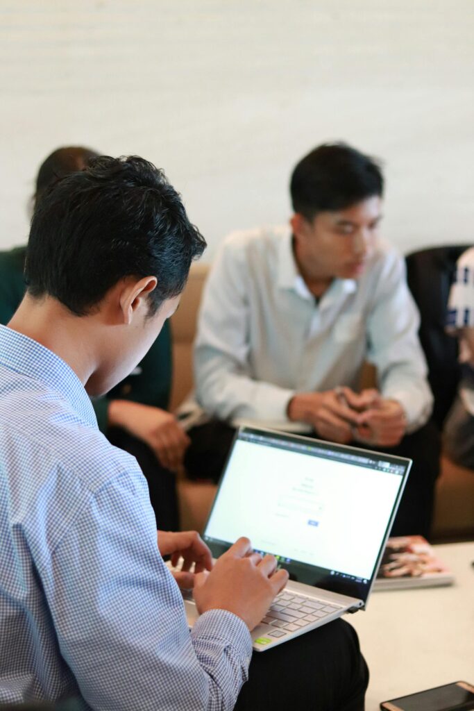 Professionals working on laptops in office.