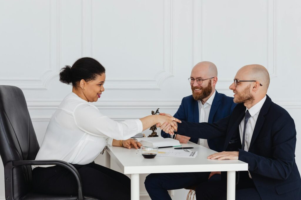 Professionals shaking hands during a meeting.
