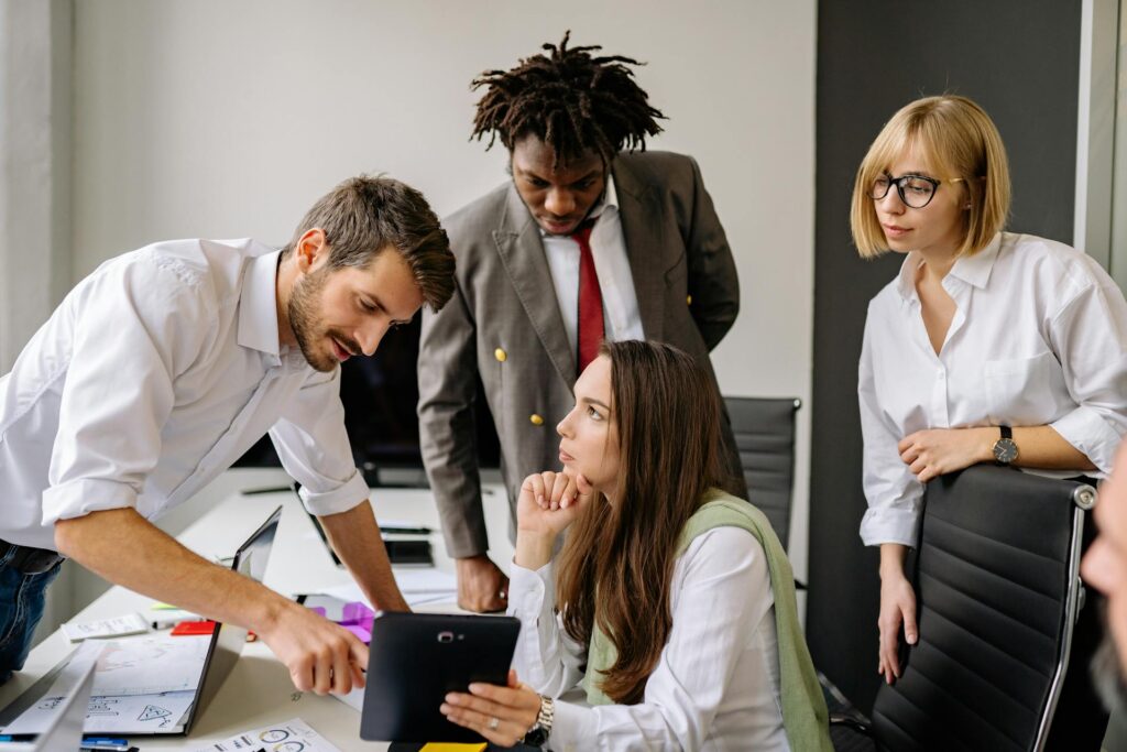Diverse team discussing project in modern office.